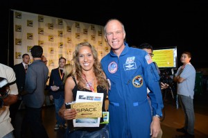 Photo by ©WBEI. Chief Test Pilot/former NASA Astronaut Richard Searfoss (right) and space flight winner Mercedes Becerra of Paso Robles. 